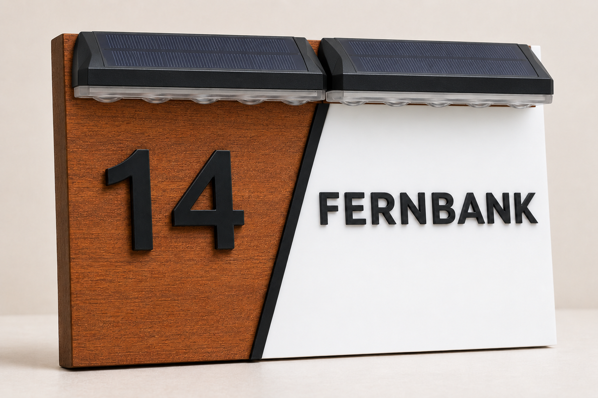 A modern 3D-printed desk calendar displaying the 14th of a month, with a split design of brown woodgrain on the left and white on the right, featuring solar-powered LED lights on top and the word 'FERNBANK' printed on the front.lumorastudio.ie lumora craft studio