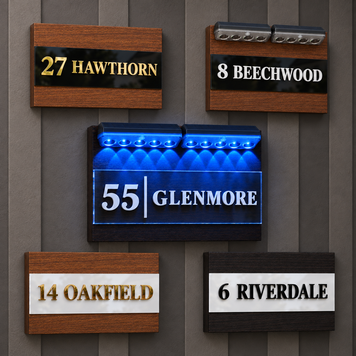 Five decorative house number signs mounted on a gray wood-paneled wall. The center sign is illuminated blue and reads “55 | GLENMORE” in white. lumorastudio.ie/lumora craft studio