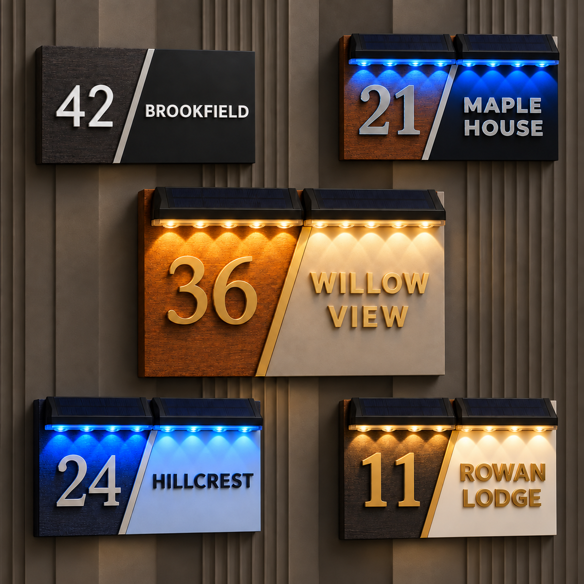Five illuminated house number and street name signs mounted on a dark wood-paneled wall. The signs feature different color schemes: black and white, blue and brown, gold and beige, blue and white, and gold and white.lumorastudio.ie lumora craft studioPersonalised diagonal wood and acrylic house plaque with raised lettering